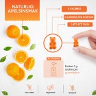 Bilden visar ett par apelsiner skurna och hela för att visa att den vingummibjörnar från WeightWorlds C-Vitamin Gummies för att visa att det är en naturlig smak av apelsin